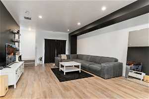 Hardwood floored living room featuring TV