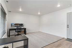 Hardwood floored office with natural light and TV