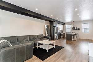 Hardwood floored living room featuring natural light