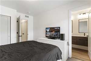 Bedroom featuring hardwood flooring and TV