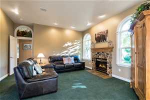 Main level family room with large windows and stone fireplace