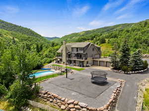 Exterior space with fire pit and a swimming pool