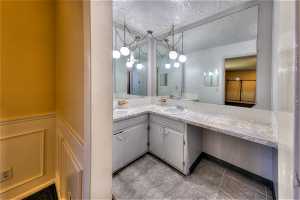 Bathroom with tile flooring, oversized vanity, and mirror