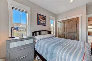 Bedroom with multiple windows and light hardwood flooring