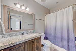 Bathroom with vanity, mirror, and tile flooring
