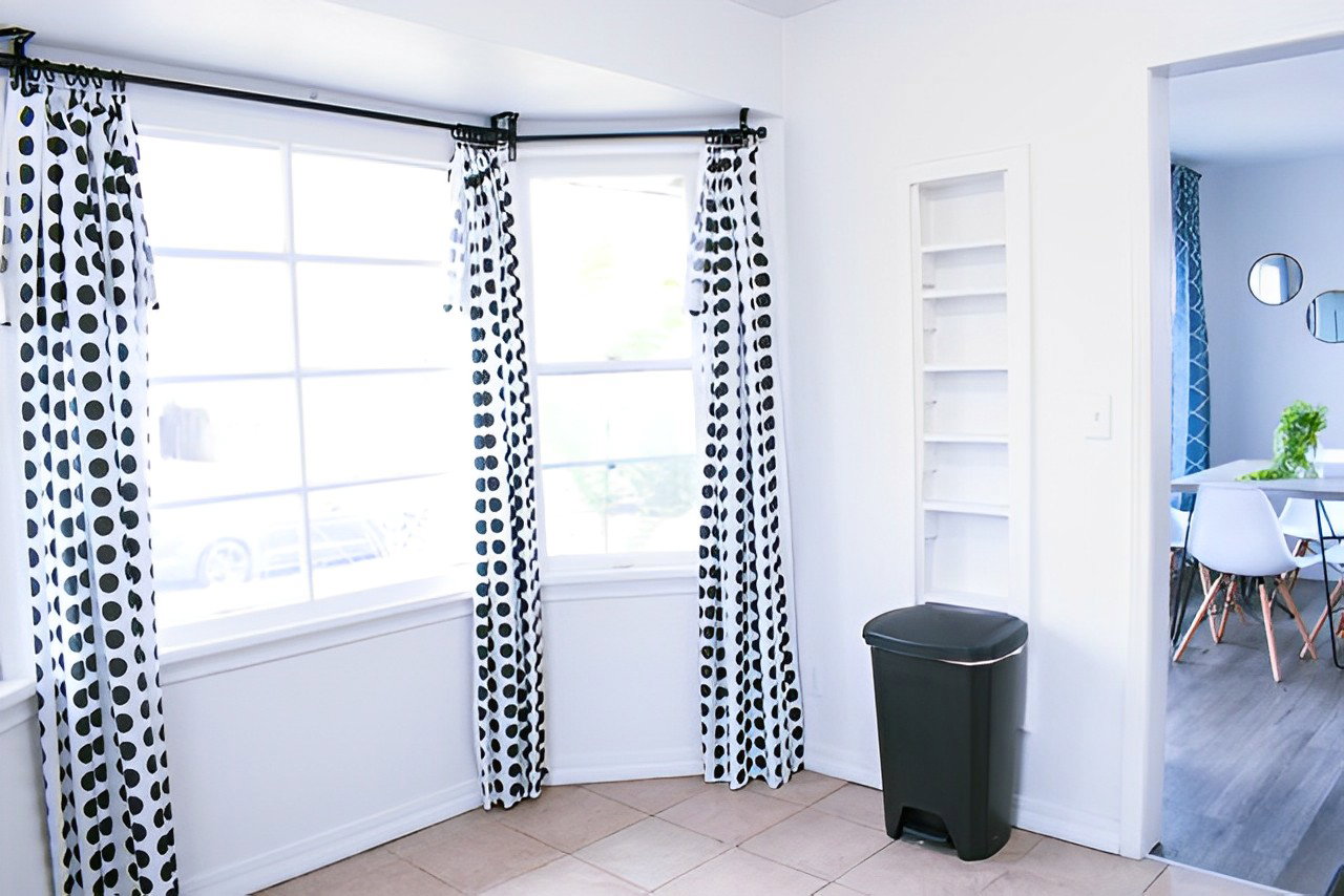 Bathroom featuring built in shelves and light tile floors
