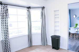 Bathroom featuring built in shelves and light tile floors