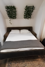 Hardwood floored bedroom with vaulted ceiling