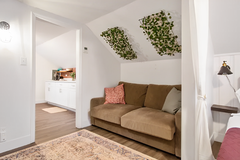 Living room with vaulted ceiling and light parquet floors