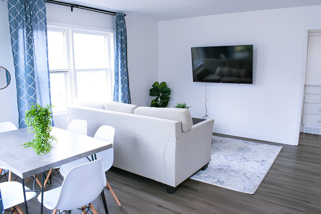 Hardwood floored living room featuring TV