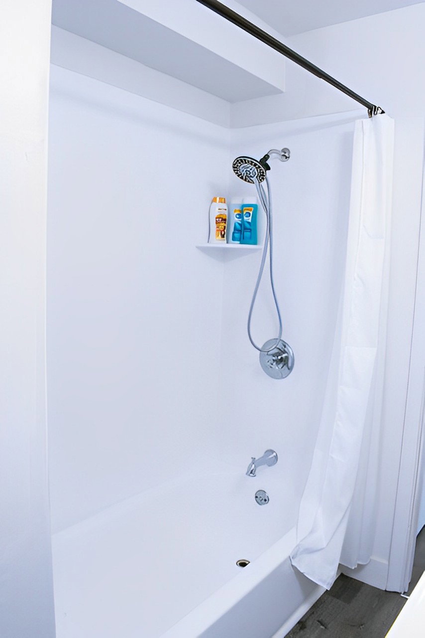 Bathroom with shower / bath combo with shower curtain and hardwood floors