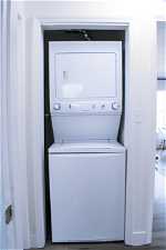 Clothes washing area featuring washer / dryer and hardwood floors