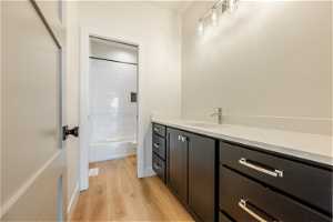 2nd Level Full bathroom with vanity, light hardwood flooring, and tiled shower / bath combo