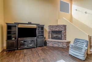 Living room featuring TV and dark hardwood floors