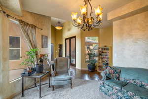 Living room featuring a notable chandelier and light parquet flooring