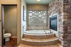 Bathroom featuring tile flooring and tiled bath