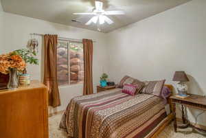 Bedroom featuring ceiling fan and light carpet