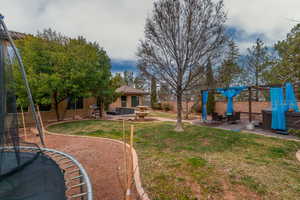 View of yard with a playground and a patio