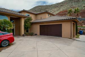 Mediterranean / spanish-style house featuring garage and a mountain view