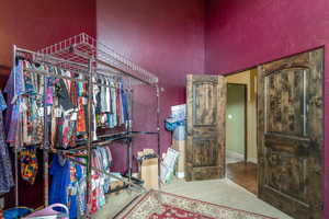 Walk in closet with light tile floors