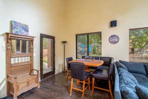 Hardwood floored dining area with a high ceiling