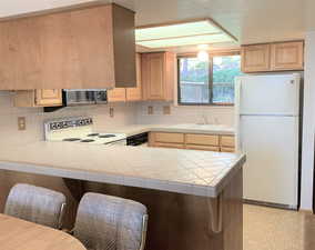 Kitchen has bar area ready for barstools to increase seating.