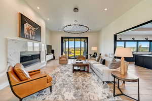 Living room featuring a high end fireplace and light wood-type flooring