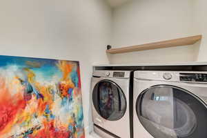 Washroom featuring washer and dryer