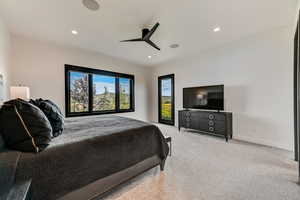 Carpeted bedroom with ceiling fan