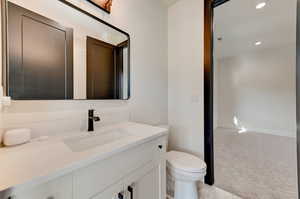 Bathroom featuring toilet, tile floors, and oversized vanity