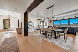 Dining room featuring an inviting chandelier, a wealth of natural light, and light hardwood / wood-style floors