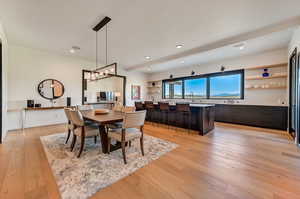 Dining space with an inviting chandelier, sink, and light hardwood / wood-style floors