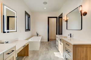 Bathroom with a tub and vanity