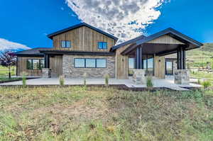 Rear view of property featuring a patio area