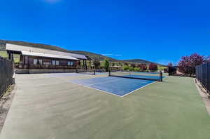 View of tennis court with a mountain view