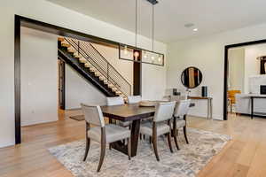 Dining space featuring light hardwood / wood-style flooring and a notable chandelier