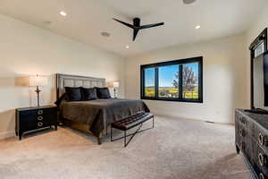 Bedroom with ceiling fan and light colored carpet