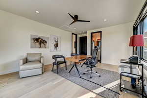 Office featuring ceiling fan and light hardwood / wood-style flooring