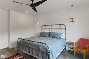 Bedroom with ceiling fan and concrete floors