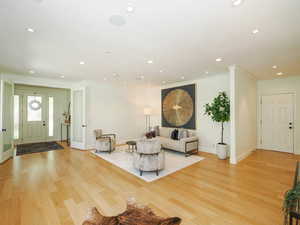 Hardwood floored living room with ornamental molding