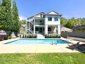 View of swimming pool with a yard