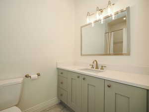 Bathroom featuring vanity, light tile flooring, and mirror