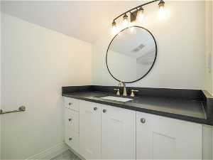 Bathroom with mirror and large vanity