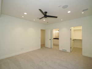 Carpeted bedroom featuring ceiling fan