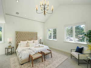 Bedroom with lofted ceiling, light carpet, and a high ceiling