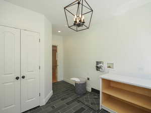 Clothes washing area featuring hardwood floors