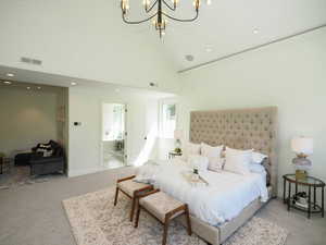 Carpeted bedroom featuring vaulted ceiling and a high ceiling