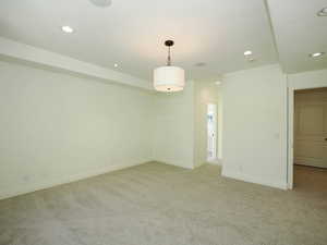 Unfurnished room featuring light carpet