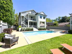 View of pool with a patio area and a yard