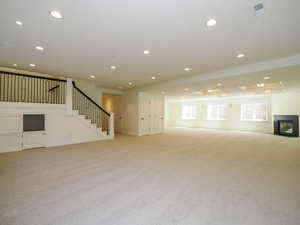 Carpeted living room with ornamental molding